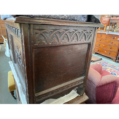 648 - A 17th century and later carved to panel oak coffer, 122cm wide, 55cm deep, 66cm high