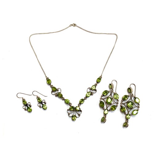 52 - A vintage silver and peridot necklace with two matching pairs of earrings, the longer pair 6.5cmL, t... 