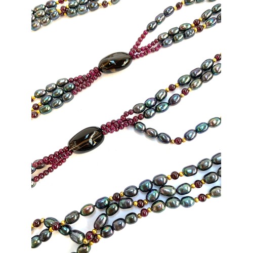 55 - Two long wrap necklaces, one strung with peacock coloured cultured pearls, garnet beads and smoky qu... 