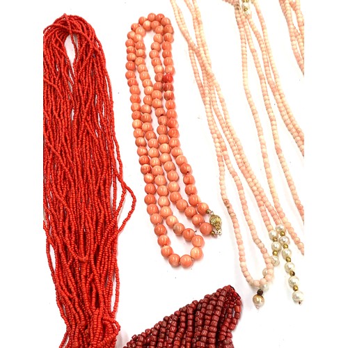 45 - A large quantity of coral and coral coloured bead necklaces and bracelets, to include branch coral, ... 