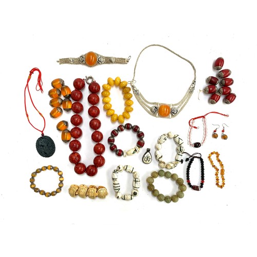 46 - A mixed lot of jewellery, mainly amber type and bakelite type beads, to include carved soapstone bra... 