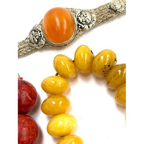 46 - A mixed lot of jewellery, mainly amber type and bakelite type beads, to include carved soapstone bra... 