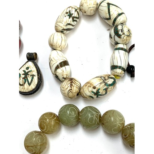 46 - A mixed lot of jewellery, mainly amber type and bakelite type beads, to include carved soapstone bra... 