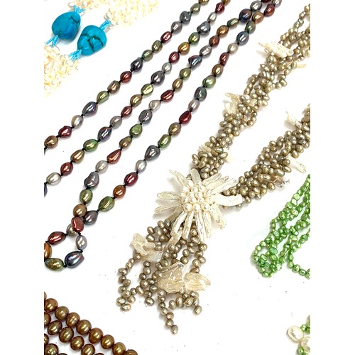 47 - A quantity of mainly coloured cultured pearl necklaces, some multi-strand, to include green, pink, b... 