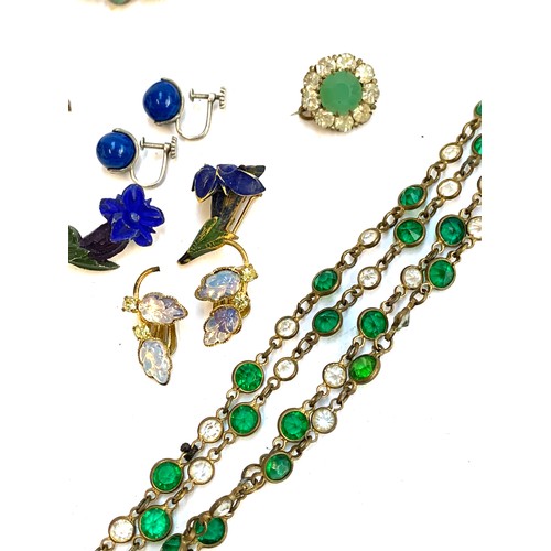 65 - A quantity of mainly Art Deco jewellery to include bezel set green and clear paste long guard chain,... 