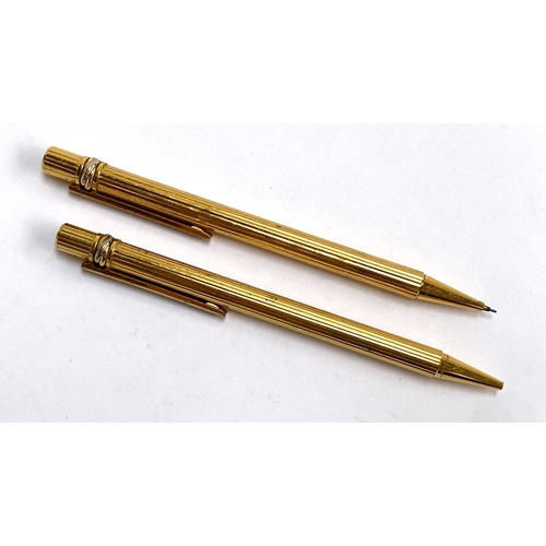 100 - A Must de Cartier 'Trinity' gold plated propelling pencil and pen (af), numbered