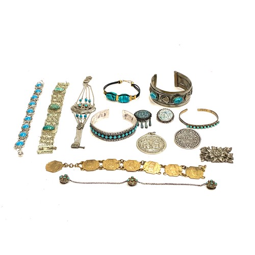 68 - A quantity of Mexican and Egyptian white metal jewellery, some set with turquoise, faience scarabs a... 