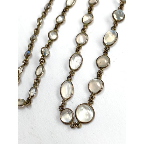 72 - A silver and bezel set moonstone riviere necklace, the largest moonstone 0.8cmD, 32cmL, 11.9g