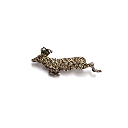 85 - An early 20th century 900 grade silver and paste brooch in the form of a leaping ram, 4cmL, 7g