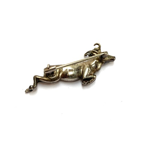 85 - An early 20th century 900 grade silver and paste brooch in the form of a leaping ram, 4cmL, 7g