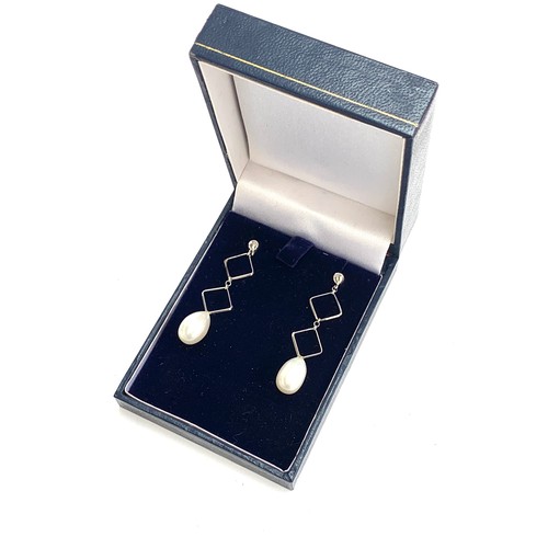 77 - A pair of 9ct white gold and cultured pearl geometric drop earrings, 4.3cm long, 3.1g gross weight