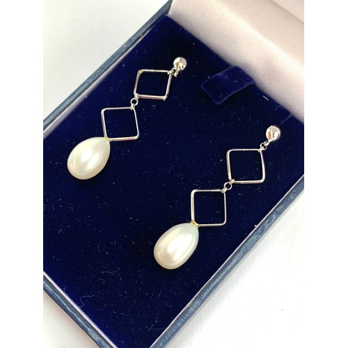 77 - A pair of 9ct white gold and cultured pearl geometric drop earrings, 4.3cm long, 3.1g gross weight