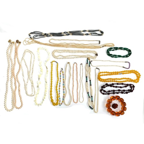 120 - A quantity of beaded necklaces to include three pearl necklaces with 9ct gold clasps; amber style br... 