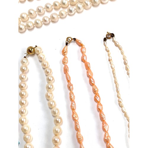 120 - A quantity of beaded necklaces to include three pearl necklaces with 9ct gold clasps; amber style br... 