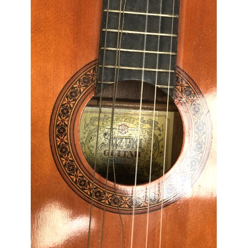 1390 - A Suzuki classical guitar, one string broken