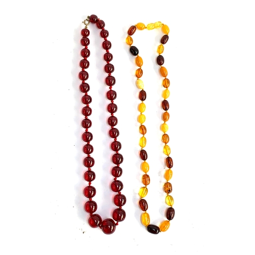 137 - A cherry amber bakelite type beaded necklace, beads graduating from approx. 0.9cm to 1.5cm, gross we... 