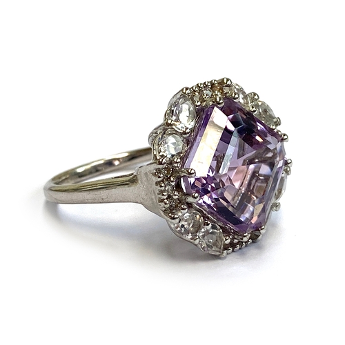 11 - A sterling silver ring set with an Asscher cut Bahia amethyst, 8.1cts, surrounded by white topaz, si... 