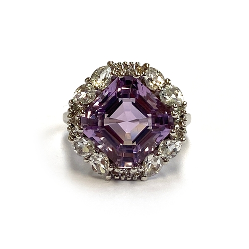 11 - A sterling silver ring set with an Asscher cut Bahia amethyst, 8.1cts, surrounded by white topaz, si... 