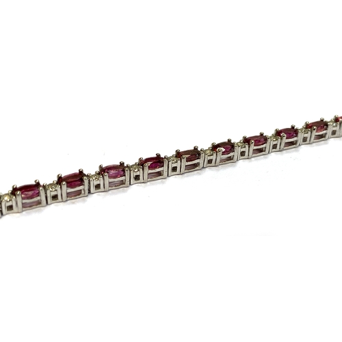 12 - A sterling silver bracelet set with alternating pink rubellite tourmaline and natural white zircons,... 