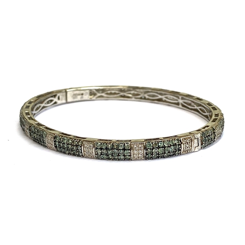 13 - A sterling silver bangle with platinum vermeil set with alexandrite, 4.8cts, and natural white zirco... 