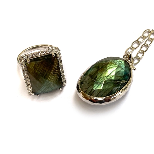 14 - A sterling silver double sided pendant set with faceted labradorite, 31cts, and moonstone, 31.5cts, ... 