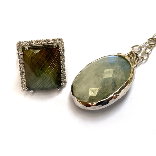 14 - A sterling silver double sided pendant set with faceted labradorite, 31cts, and moonstone, 31.5cts, ... 