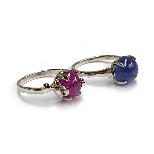 19 - A sterling silver ring set with a pink sapphire cabochon, 4.1cts, with white topaz set shoulders, si... 