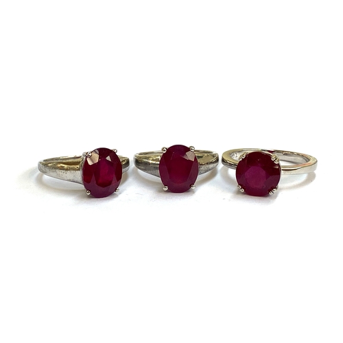 27 - Three sterling silver rand Madagascan ruby solitaire rings, one round, 5.29cts, ring size R 1/2, the... 