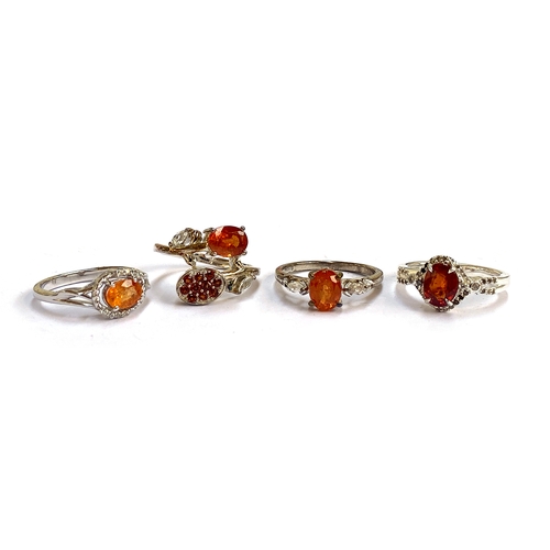 30 - Four sterling silver, mandarin garnet and white zircon rings, the garnets 1.64cts, 1.93cts, 1.34cts ... 