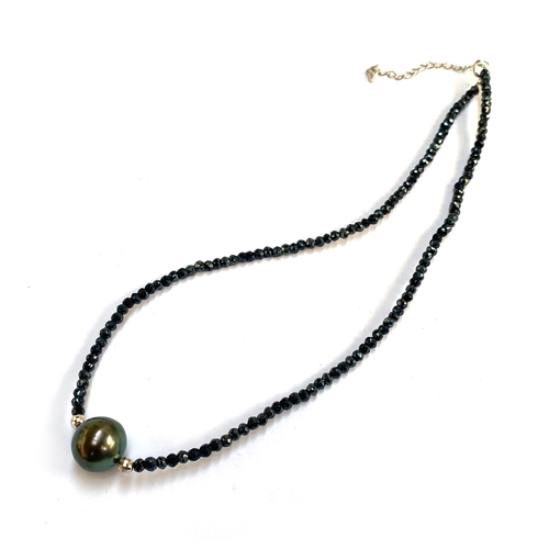 37 - A black spinel bead necklace with central Tahitian cultured grey pearl, the spinels totalling 40cts,... 