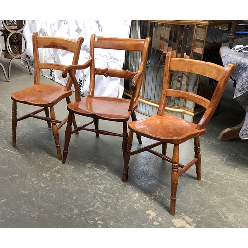 1252 - A set of three elm and fruitwood scroll back Windsor chairs, one with arms