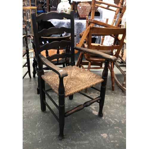 1255 - An ash ladderback open armchair, with rush seat and peripheral stretchers, 60cmW