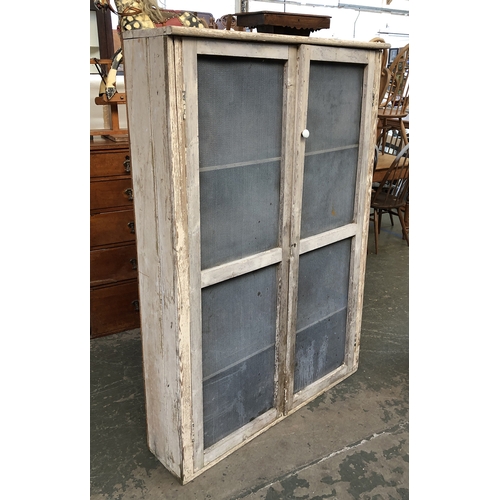 1285 - A 19th century shallow pine country house larder cupboard, the grille doors opening to three shelves... 