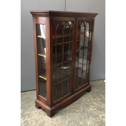 1358 - A 20th century glazed cabinet, the doors with Gothic astragal glazing, opening to three shelves, 99x... 