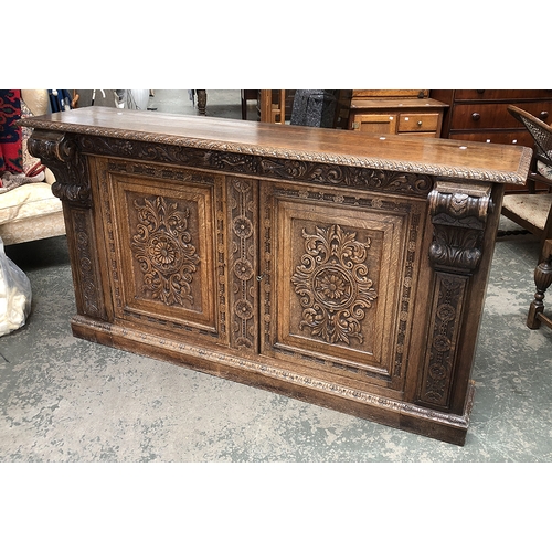 1356 - A well carved 19th century oak sideboard/buffet, the moulded top over a frieze carved with grapes, f... 