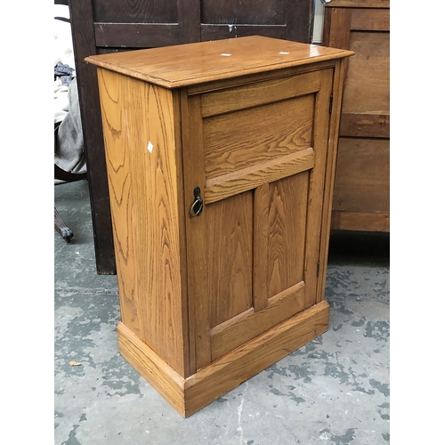 1298 - An ash cabinet with panelled door opening to shelves with a slatted back, 60x36x91cmH