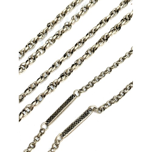 140 - Four white metal chains, to include a twisted link guard chain, 75cmL, with matching smaller chain, ... 