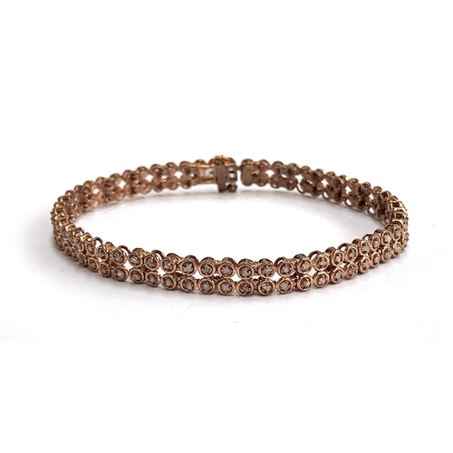 124 - A 925 silver rose gold vermeil bracelet set with natural pink diamonds totalling 0.5cts, 19.5cmL