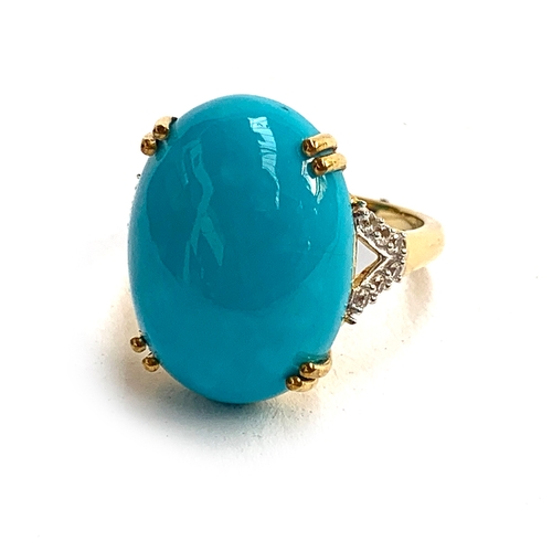 130 - A 925 silver ring set with a large sleeping beauty turquoise cabochon, 14.1cts, the shoulders set wi... 