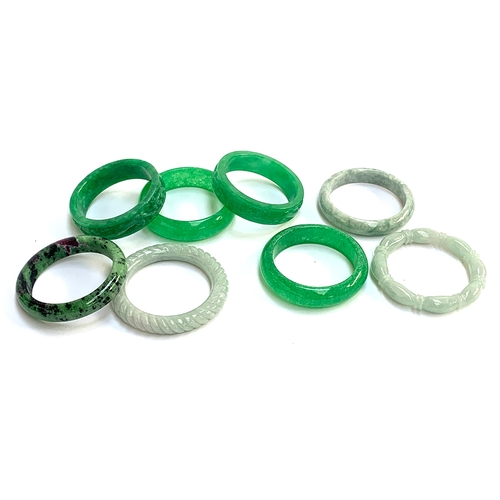 132 - Six carved jade bangles; together with a ruby zoisite bangle