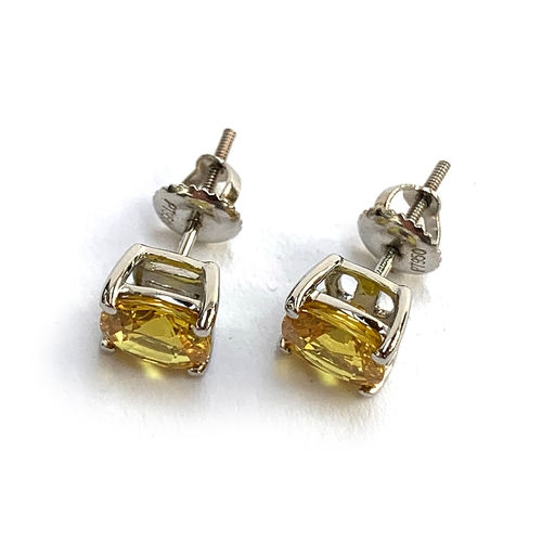 133 - A pair of 'Rhapsody' platinum and yellow sapphire stud earrings, the studs with screw fittings, the ... 