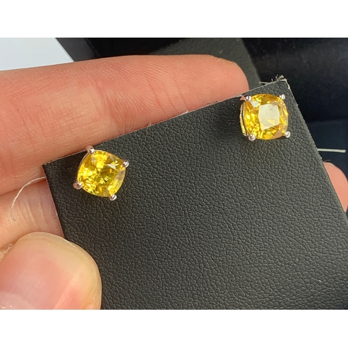 134 - A pair of 'Rhapsody' platinum and yellow sapphire stud earrings, the studs with screw fittings, the ... 