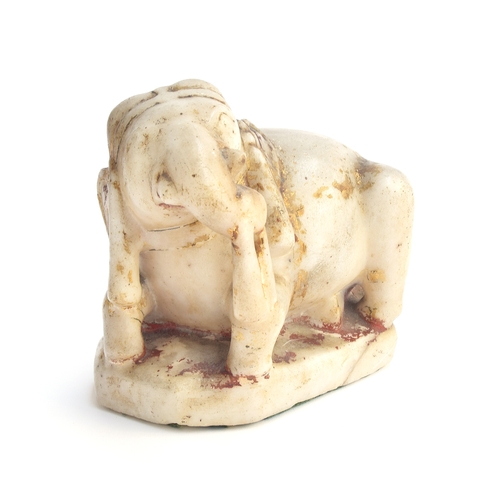 228 - A 19th century Indian carved alabaster figure of an elephant, remnants of gilt paint, 13cm high