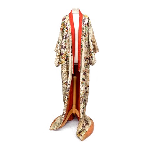 A 1920s Japanese kimono robe, cream silk allover embroidered with wisteria and fish scale pattern, with gold thread detail and orange silk lining, 124cm wide, 174cm long