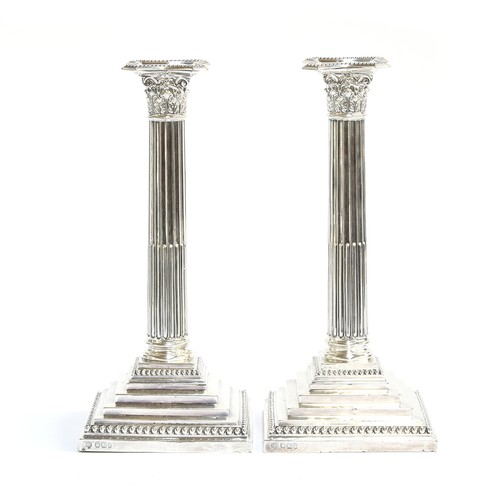 100 - A pair of large loaded silver candlesticks in Neoclassical style, by Hawksworth, Eyre & Co Ltd, Shef... 