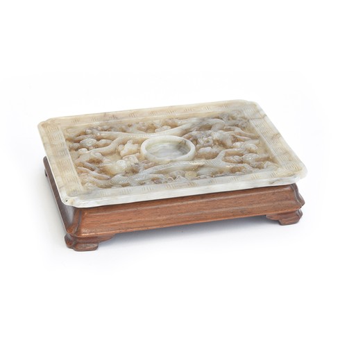 205 - A Chinese grey jade cup stand, of rectangular panel form with canted corners, intricately carved in ... 