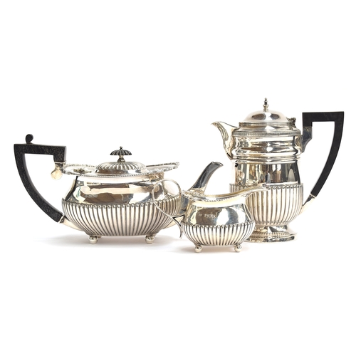 56 - A three piece silver tea and coffee set by William Hutton & Sons, London and Sheffield 1897, all wit... 