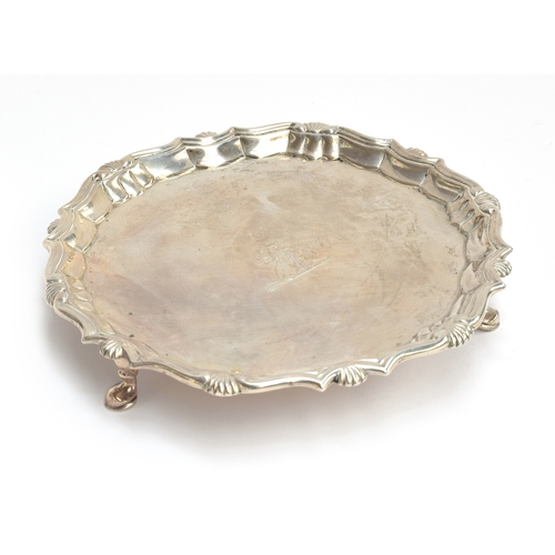 72 - A George III shaped silver salver by Robert Abercromby, London 1765, on three hoof feet, 20cm diamet... 