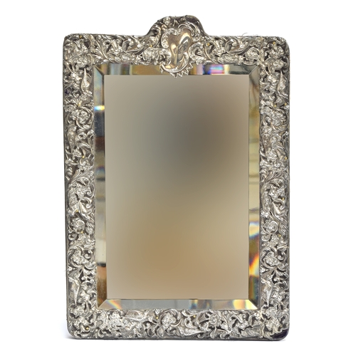 92 - A late Victorian chased silver dressing mirror, with bevelled plate, by William Comyns & Sons, Londo... 