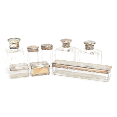 93 - A quantity of silver topped dressing table items, comprising two small rectangular pots, two cylindr... 